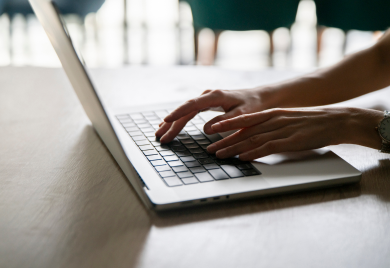 professional-woman-typing-on-a-laptop-keyboard